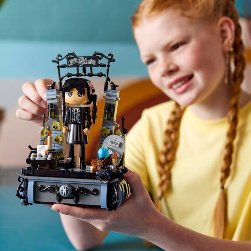 Child building the LEGO 76780 Wednesday Addams Figure set