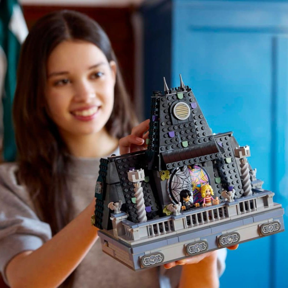 Teenager building the LEGO 76781 Wednesday & Enid's Dorm Room set