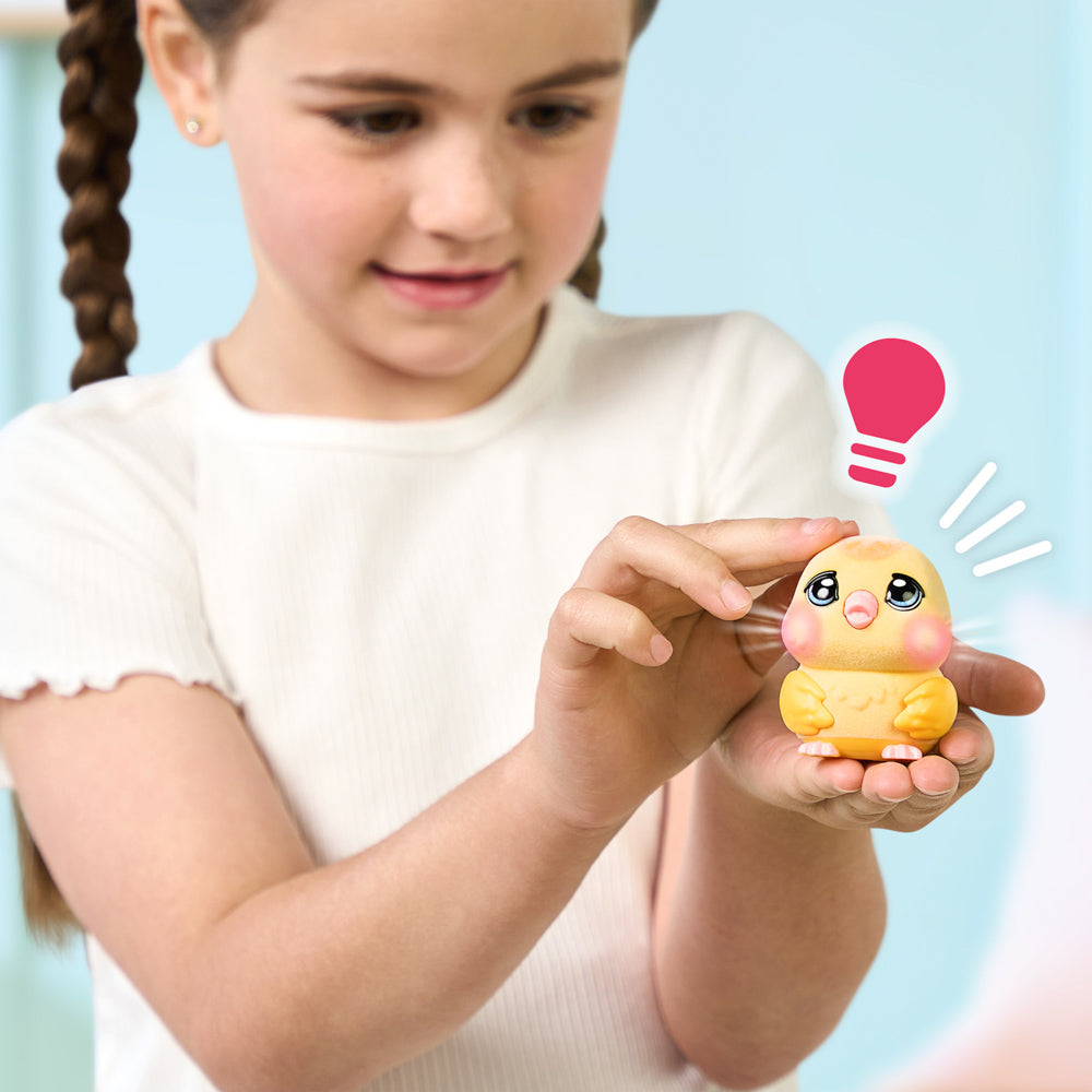 Child playing with the Little Live Pets Ouchies Series 2 Mini Chirpy Chick Bird