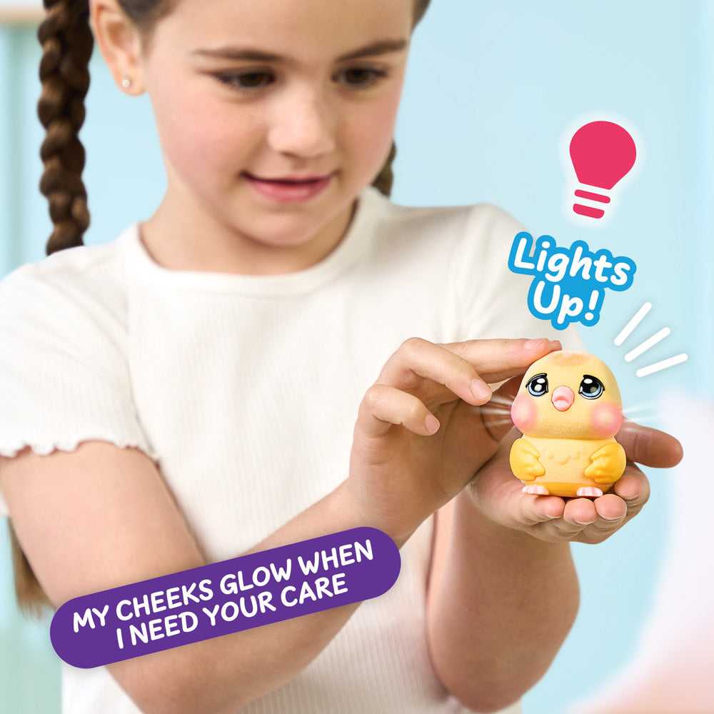 Child playing with the Little Live Pets Ouchies Series 2 Mini Chirpy Chick Bird