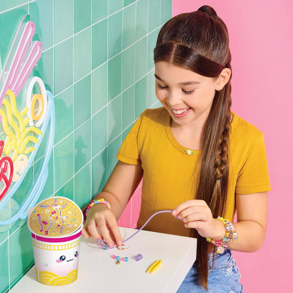 Child playing with the Make It Real Knot Noodles Bracelet DIY Kit