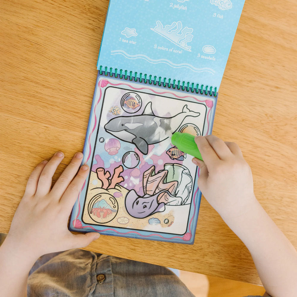 Child using the Melissa & Doug Water Wow! Water-Reveal Pad for paint-free art - Animals