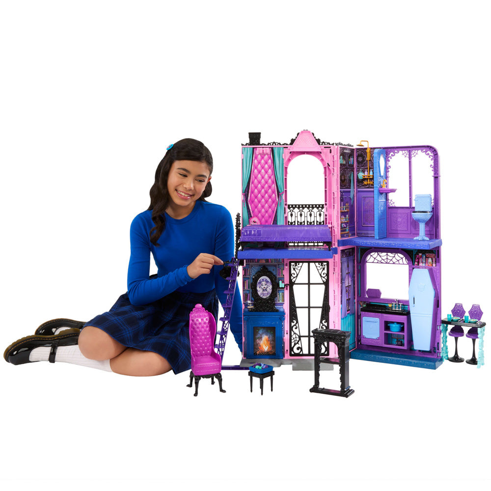 Girl playing with the Monster High Boo-Tique Hotel dollhouse