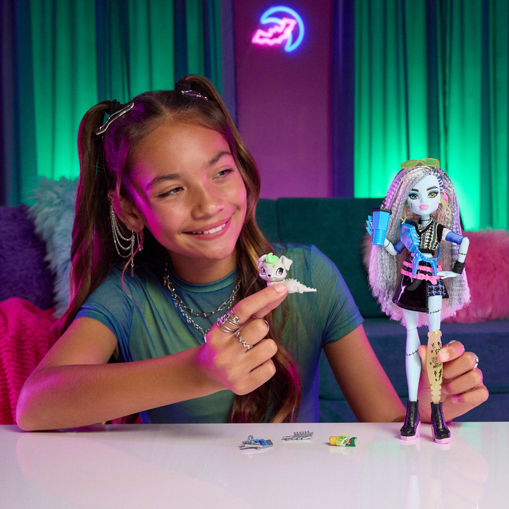 Tween playing with the Monster High Fashion Doll - Frankie Stein with blue skin