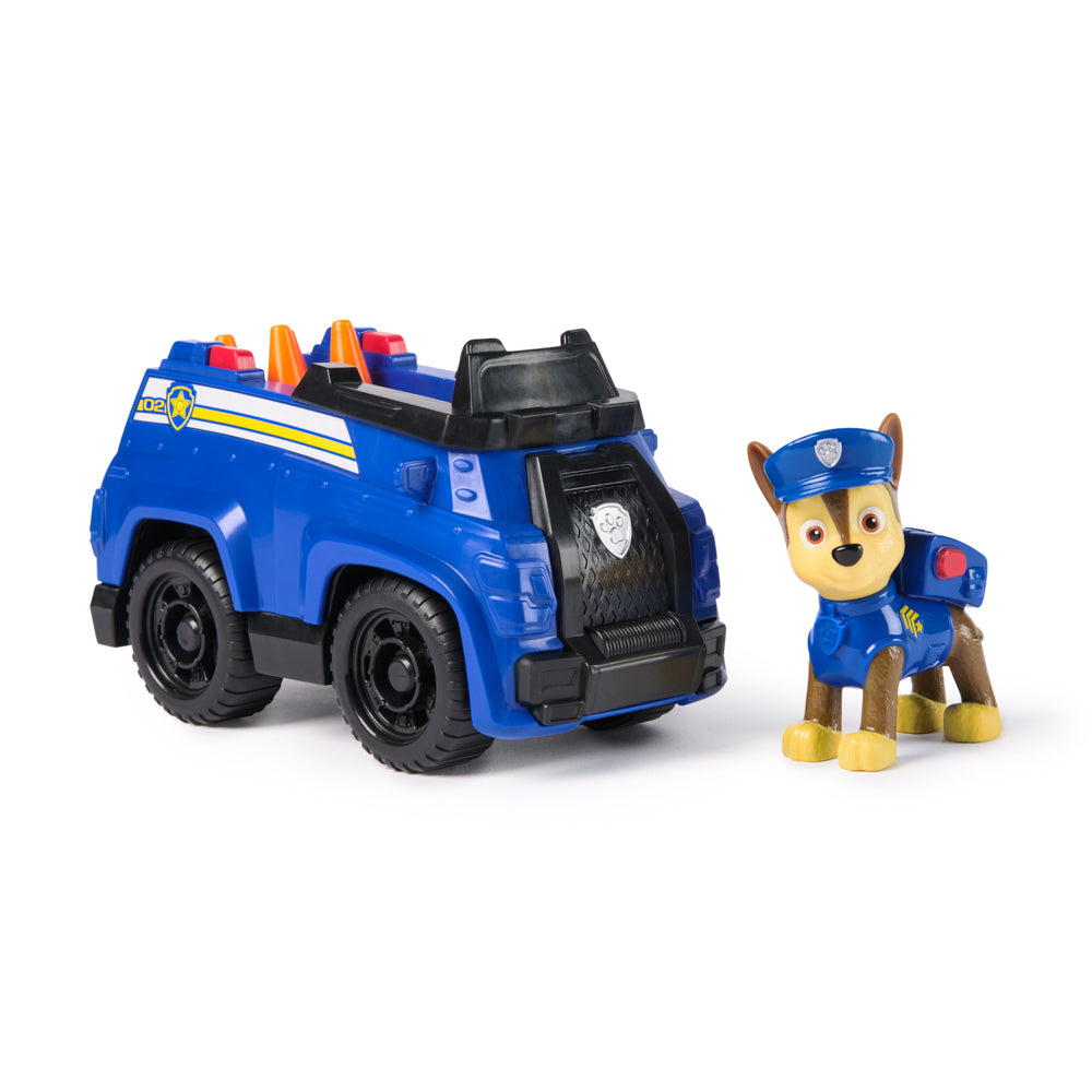 Chase standing next to car, in the PAW Patrol Basic Rescue Vehicle Chase Dog playset