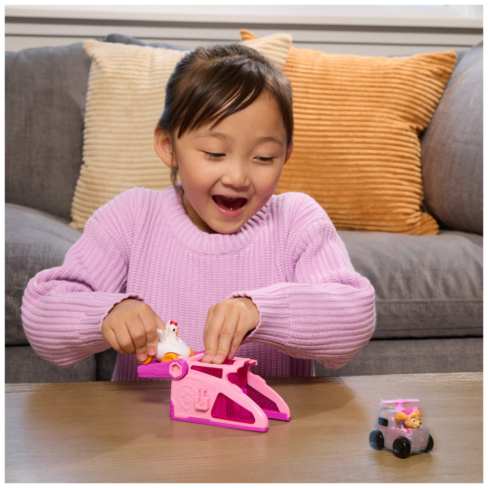 Child playing with the PAW Patrol Pup Squad Launchers Pink Toy Car - Skye & Chicken