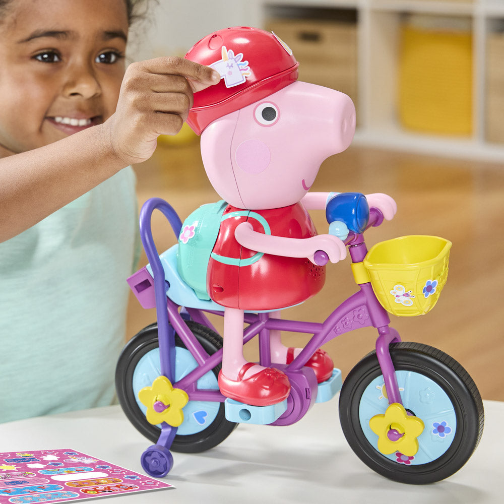 Child putting helmet on the Peppa Pig: Ready Pedal Go Peppa on push stick.