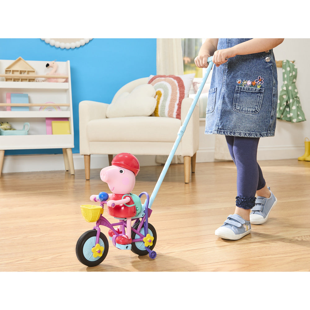 Child pushing the Peppa Pig: Ready Pedal Go Peppa on push stick.