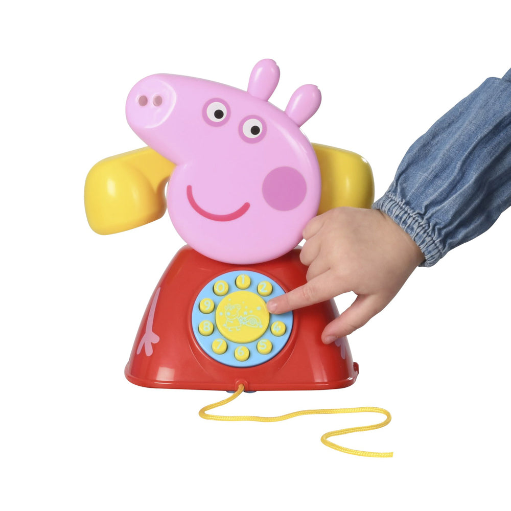 Child pressing buttons on the Peppa Pig Peppa's Telephone phone with cord
