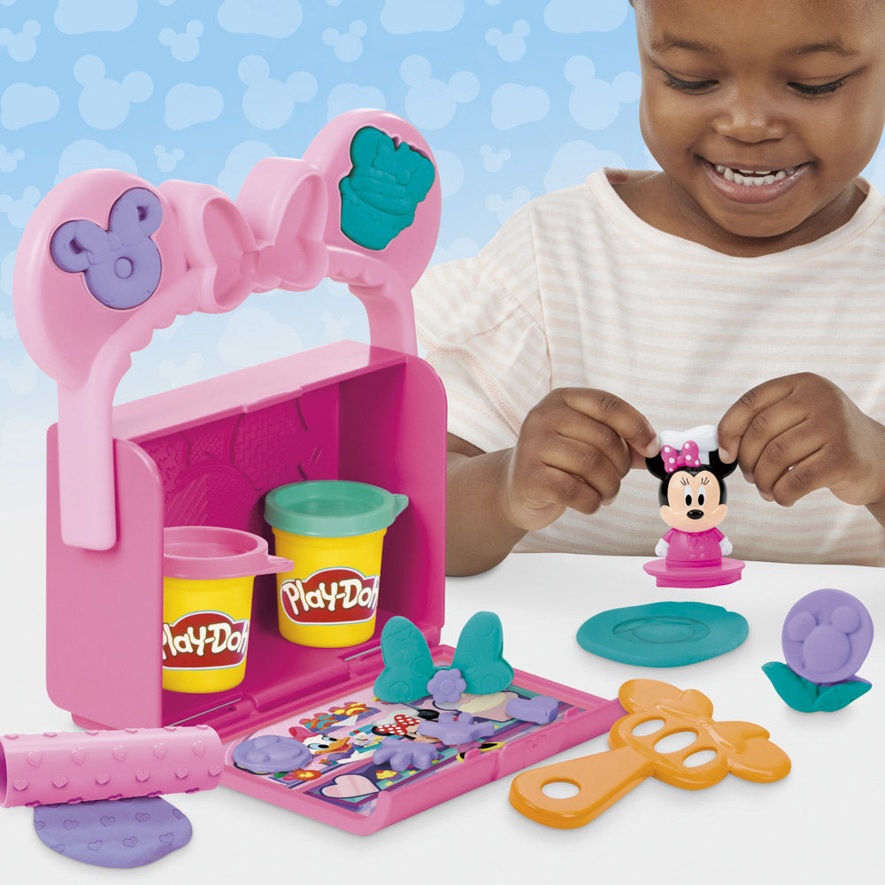 Child playing with the Play-Doh Disney Junior Mickey Mouse Clubhouse Minnie On-The-Go Bakery Playset