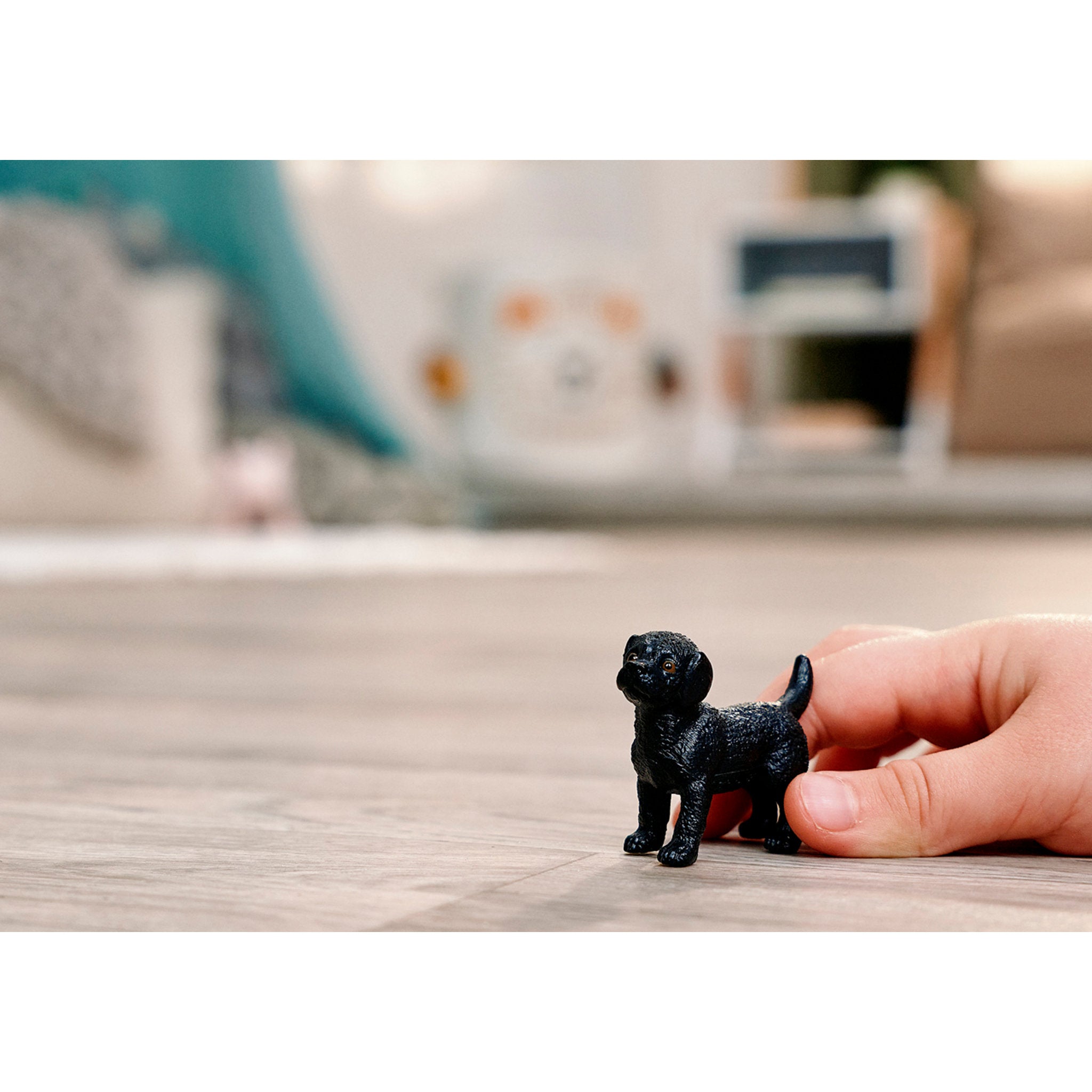 Child playing with the Schleich Black Labrador Retriever Puppy dog durable plastic figure