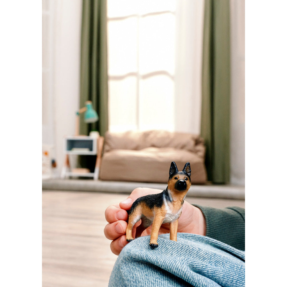 Child playing with the Schleich German Shepherd Female dog figure durable plastic toy