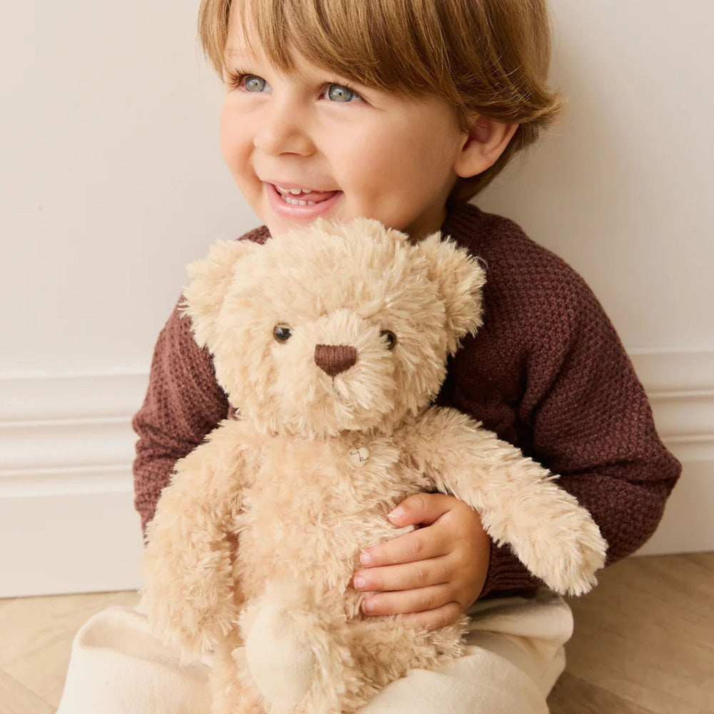 Child holding the Snuggle Bunnies Arthur the Bear Plush soft toy