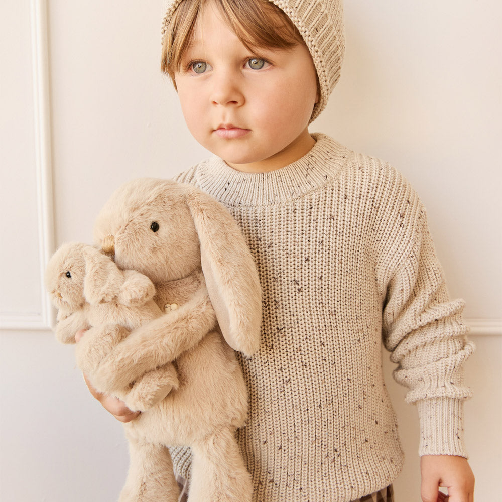 Child holding the Snuggle Bunnies Hugging Baby soft toy - Caramel