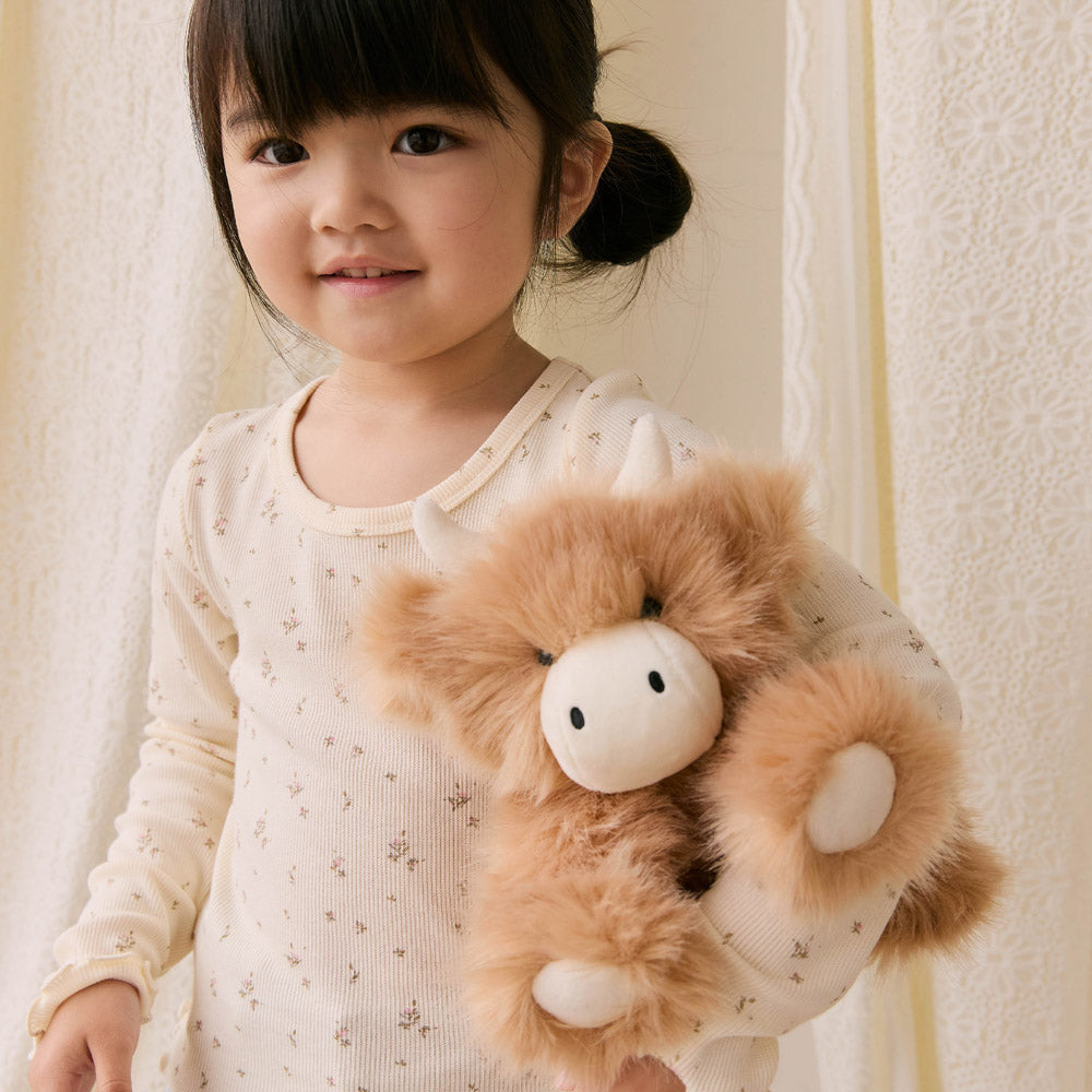 Child holding the Snuggle Bunnies Hilda the Highland Cow Caramel - 20cm Plush soft toy
