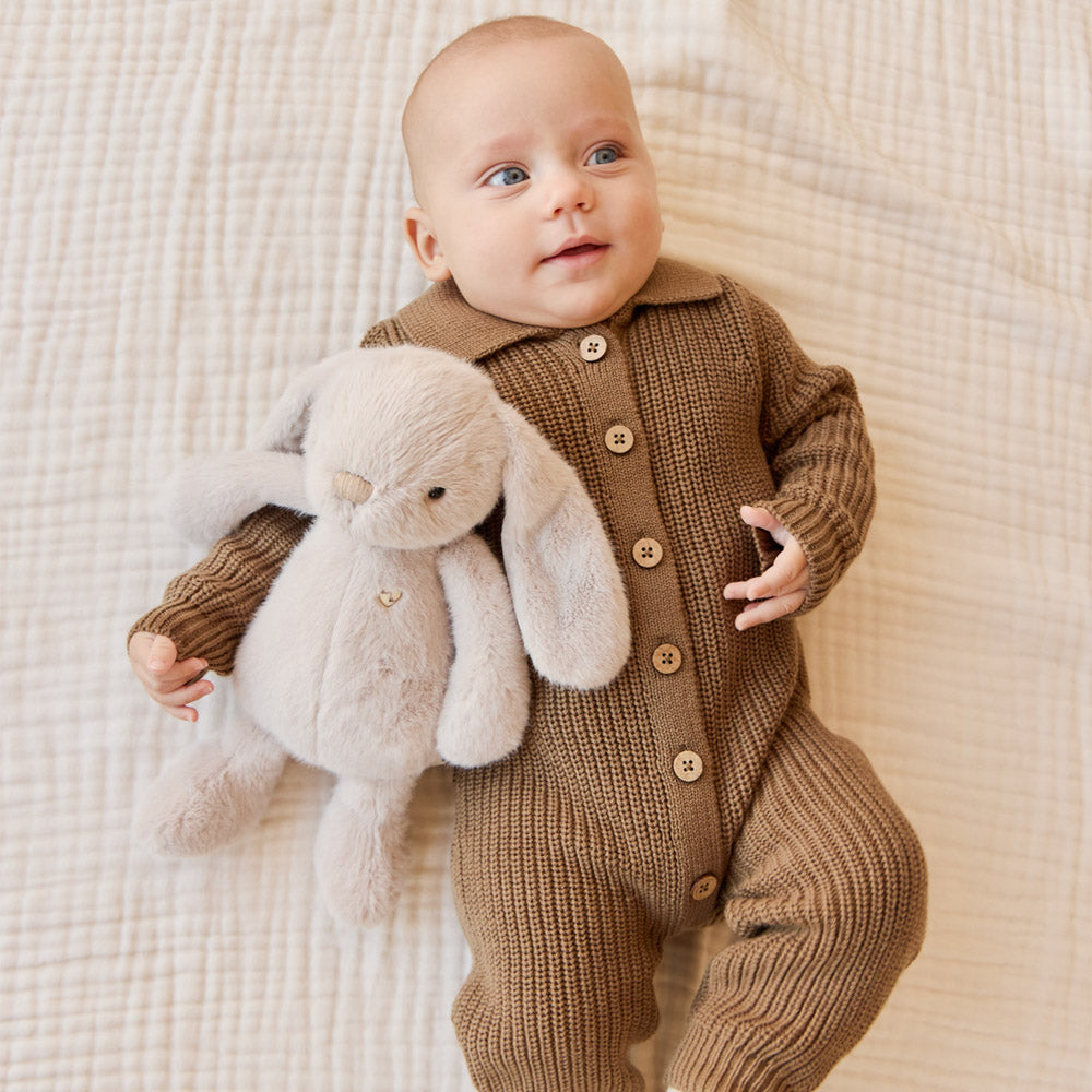 Baby holding the Snuggle Bunnies Penelope the Bunny 30cm Plush Soft Toy - Beige