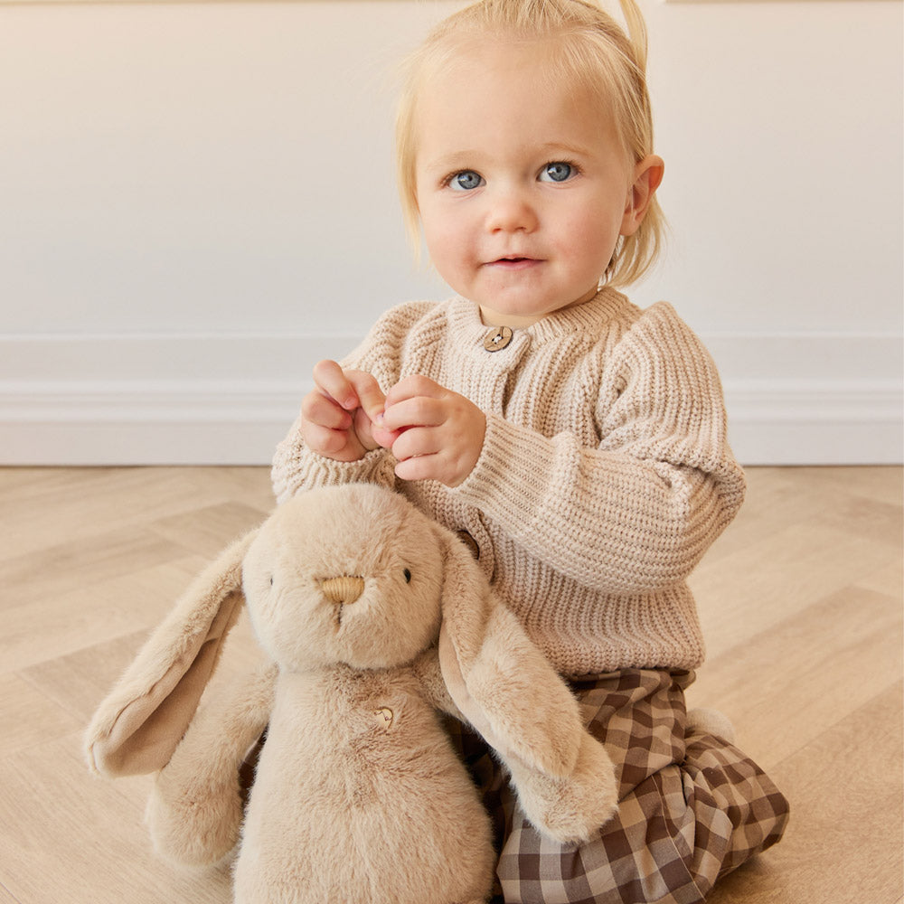 Baby holding the Snuggle Bunnies Penelope the Bunny 30cm Plush Soft Toy - Caramel