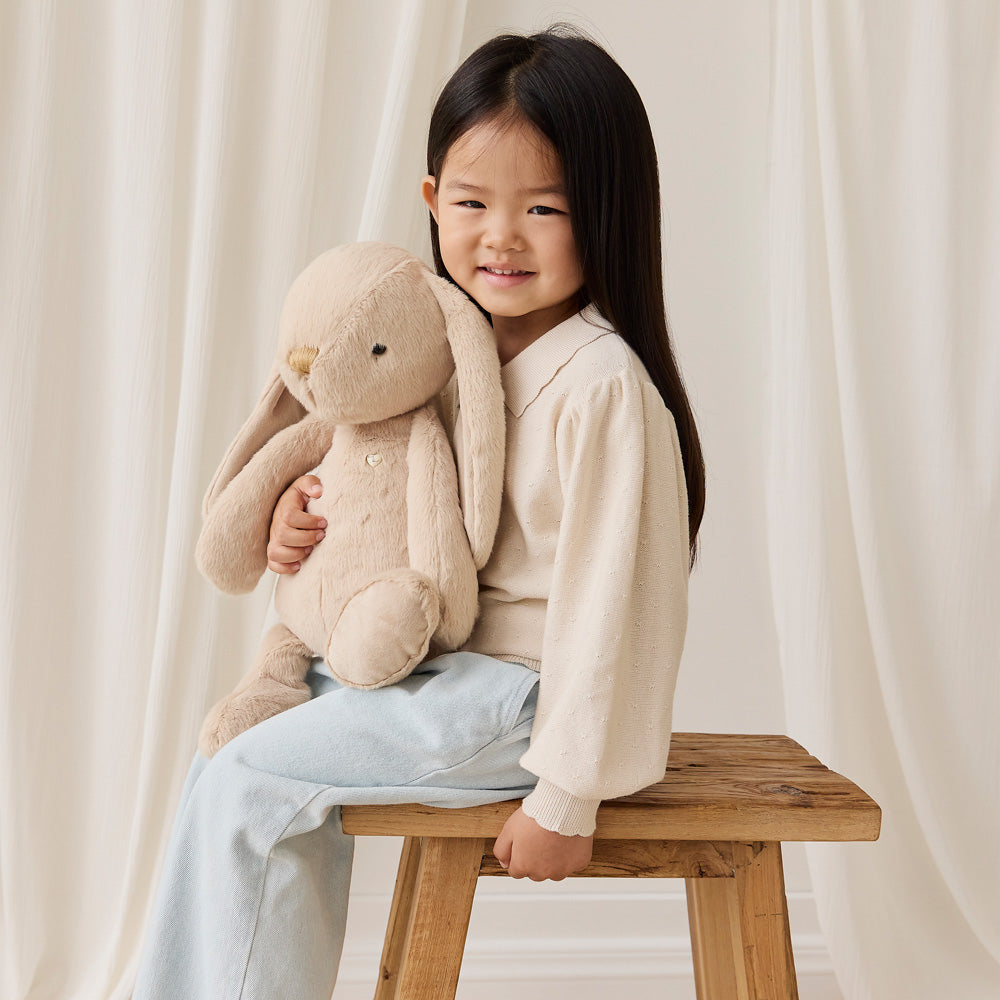 Child holding the Snuggle Bunnies Penelope the Bunny 45cm Plush Soft Toy - Caramel