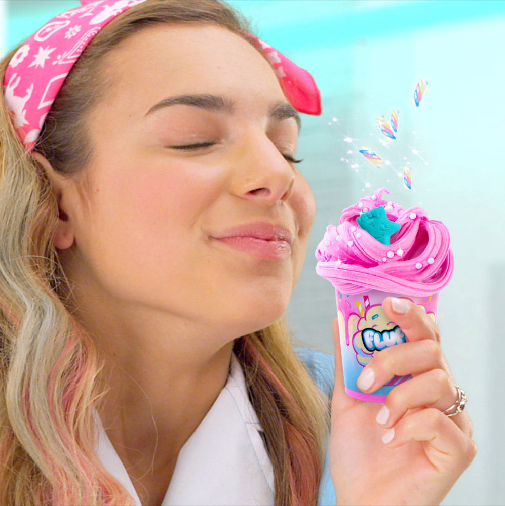Girl smelling the So Slime Fluffy Pop Slime Shaker DIY sensory slime