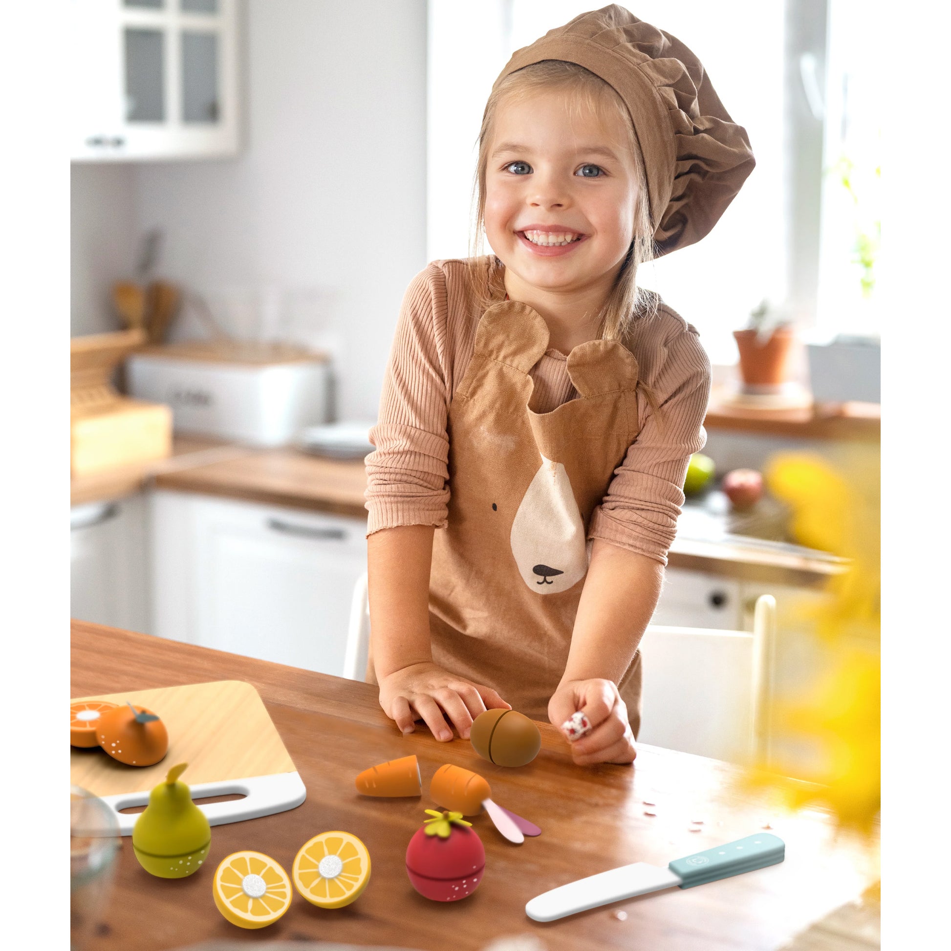 Child playing with the Speedy Monkey Wooden Fruits & Vegetables Cutting Playset