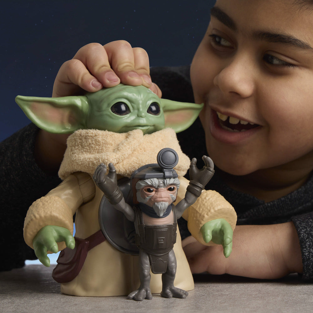 Child playing with the Star Wars The Mandalorian & Grogu Huggin' Grogu 6.5 Inch Electronic Figure & Anzellan.