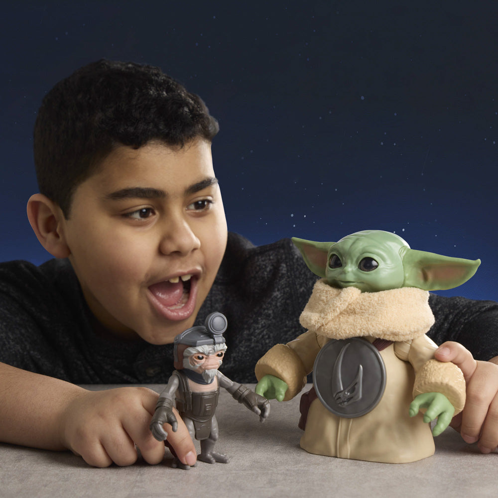 Child playing with the Star Wars The Mandalorian & Grogu Huggin' Grogu 6.5 Inch Electronic Figure & Anzellan.