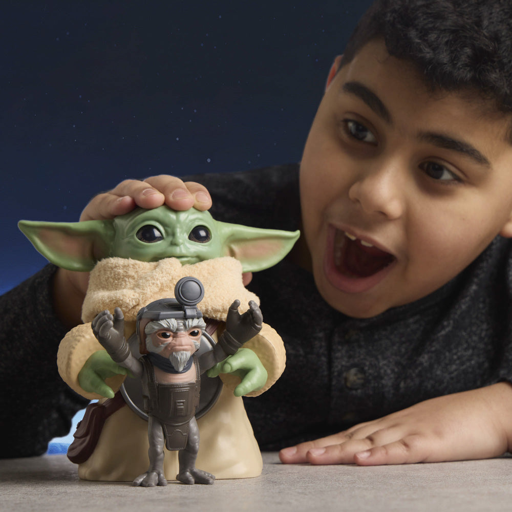Child playing with the Star Wars The Mandalorian & Grogu Huggin' Grogu 6.5 Inch Electronic Figure & Anzellan.