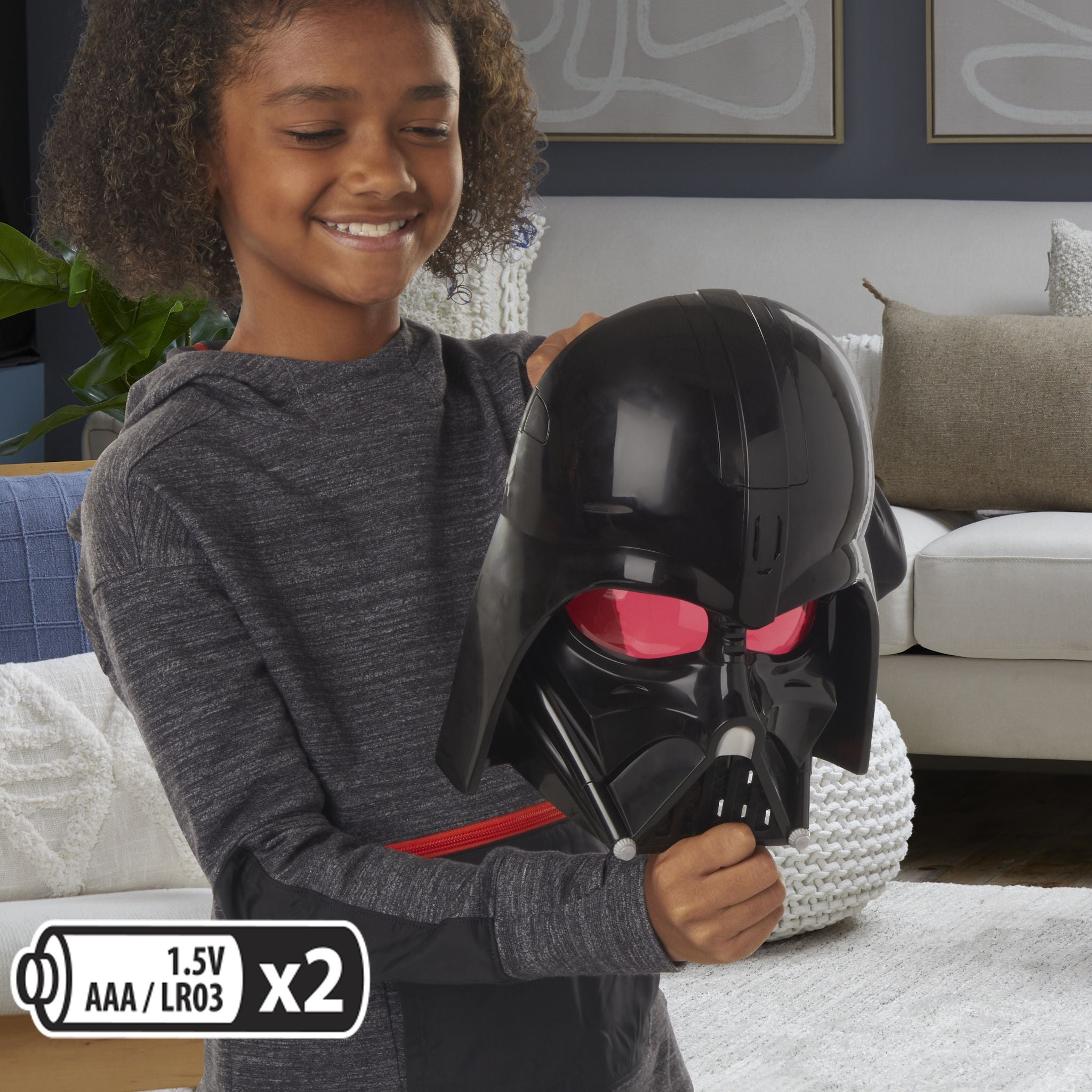Child inserting batteries into Star Wars Darth Vader Electronic Mask