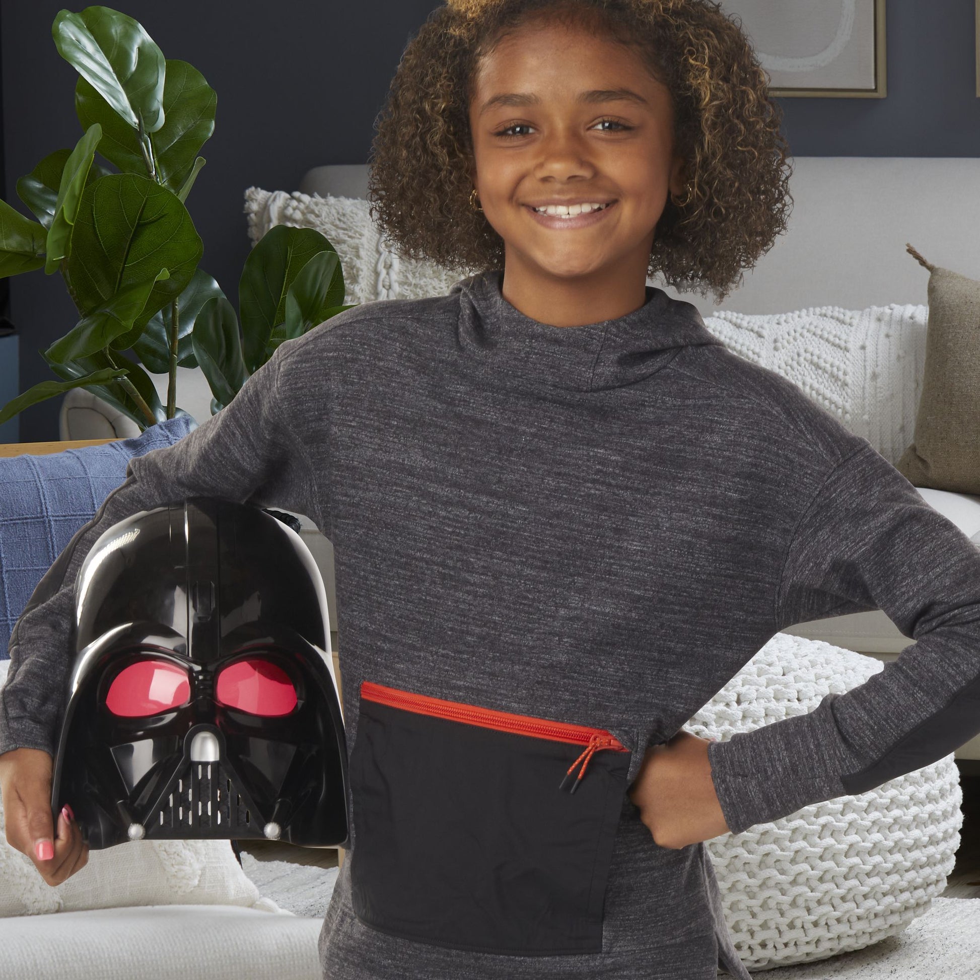 Child holding Star Wars Darth Vader Electronic Mask