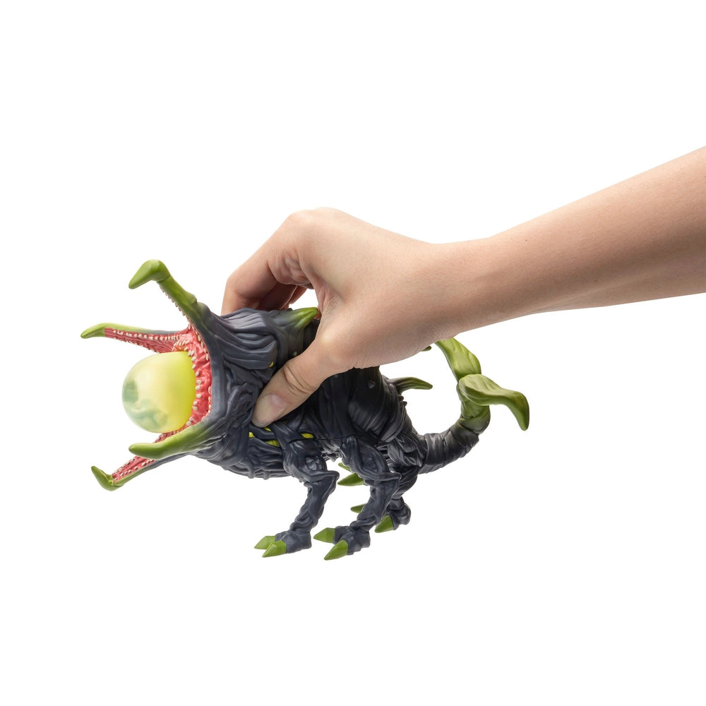Hand squishing the Stranger Things Tales From 85 Squish Figure Vine Dog