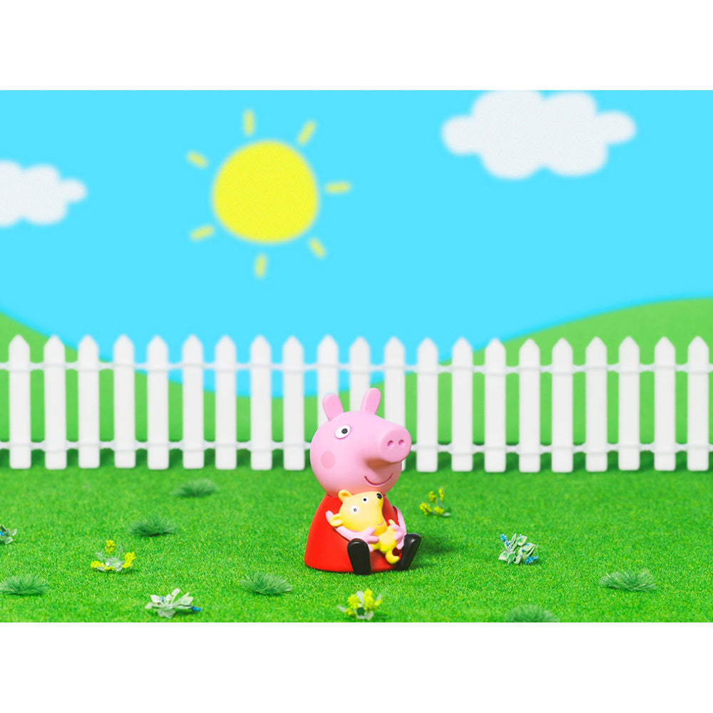 Tonies Audio Character On the Road with Peppa Pig figure, sitting in field with sun and fence
