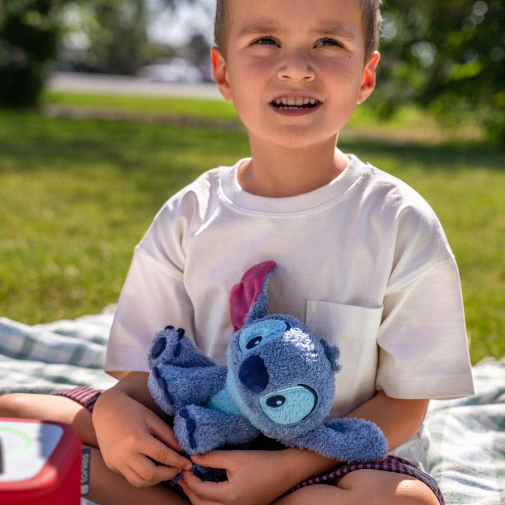 Boy playing with the Tonies Cuddle Tonie - Disney's Stitch plush figure