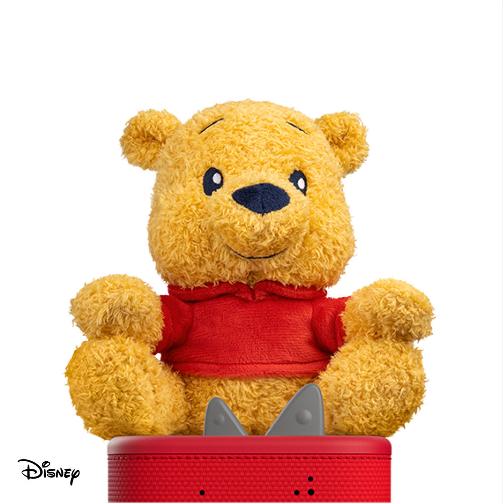 Tonies Cuddle Tonie Winnie The Pooh flush, sitting on a toniebox