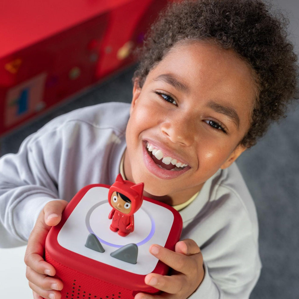 Child playing with the Tonies Toniebox 2 Creative Tonie Rubie Starter Set Sunset Red speaker
