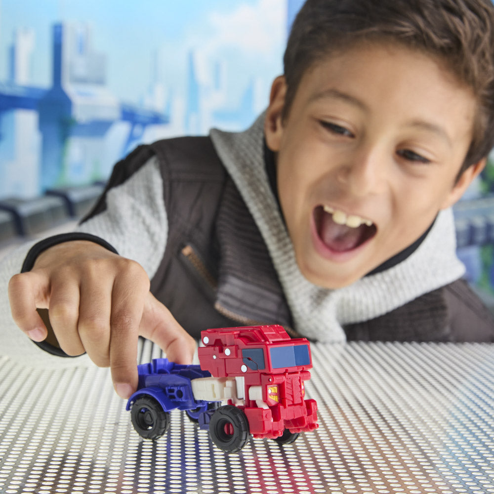 Child playing with the Transformers Cyberworld Cyber Changers Optimus Prime toy figure