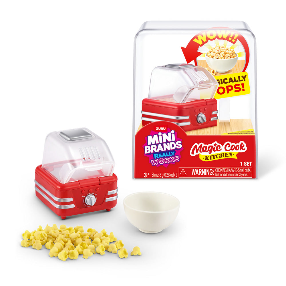 Popcorn machine in front of packaging for the ZURU Mini Bands Magic Cook Kitchen S1 Toy Popcorn Machine