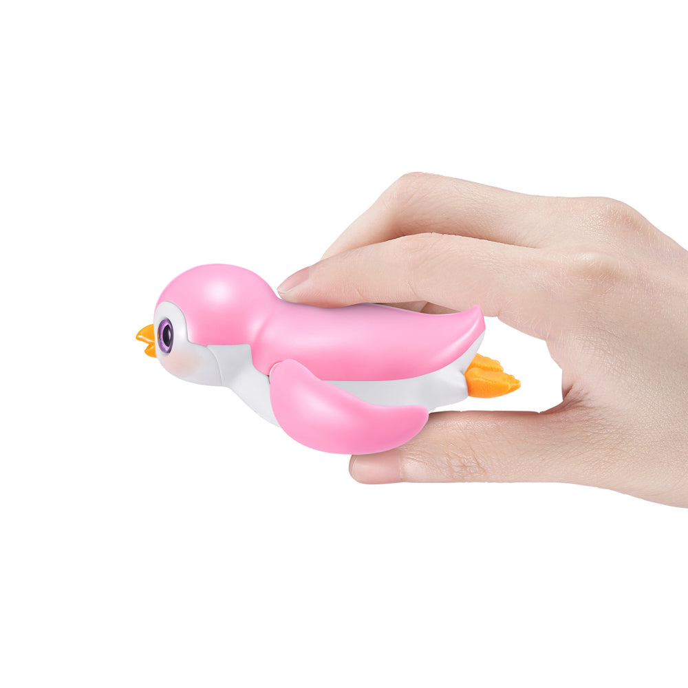 Hand holding the pink ZURU Pets Alive Swimming Penguin Series 1 Bath Toy - Assorted Styles
