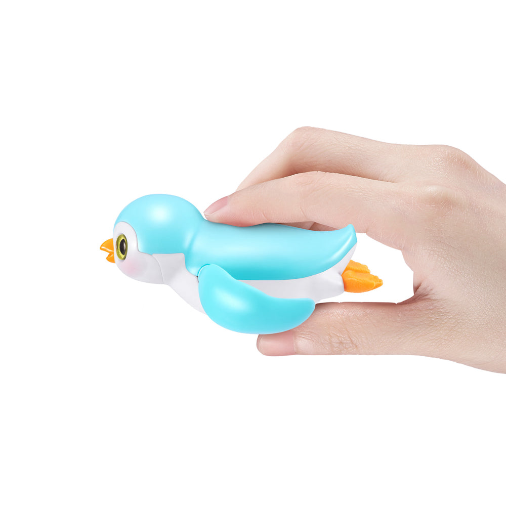 Hand holding the blue ZURU Pets Alive Swimming Penguin Series 1 Bath Toy - Assorted Styles